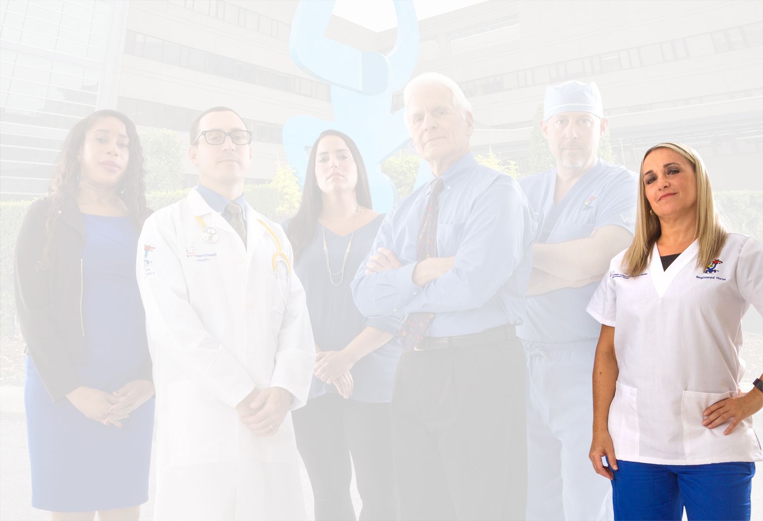 A woman wearing nurse’s scrubs stands confidently as she separates from the rest of the team and the background.